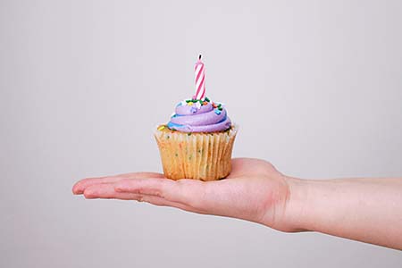 little birthday muffin on palm of a hand